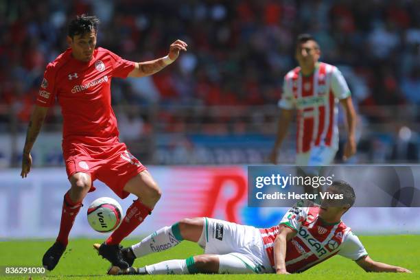 Rubens Sambueza of Toluca struggles for the ball with Xavier Baez of Necaxa during the fifth round match between Toluca and Necaxa as part of the...