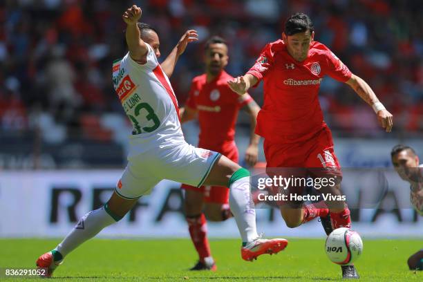 Mario de Luna of Necaxa struggles for the ball with Rubens Sambueza of Toluca during the fifth round match between Toluca and Necaxa as part of the...