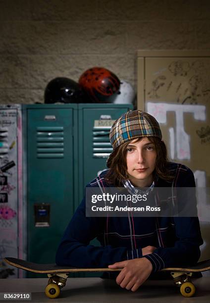 portrait of young boy with a skateboard - andersherum stock-fotos und bilder