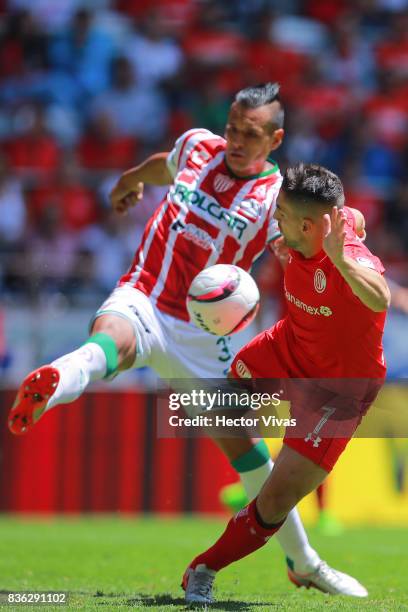 Mario de Luna of Necaxa struggles for the ball with Gabriel Hauche of Toluca during the fifth round match between Toluca and Necaxa as part of the...