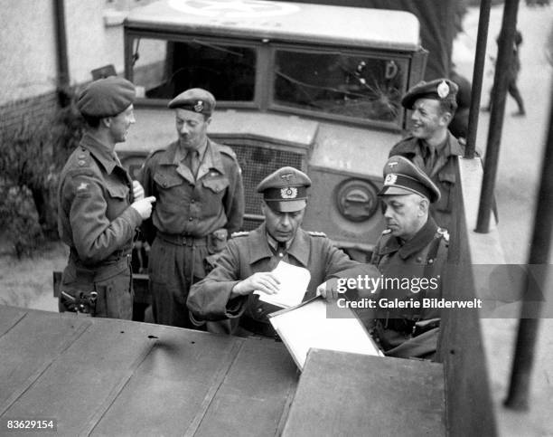 Officers of the British 2nd Army and two officers of the Wehrmacht negotiate the agreement regarding the transfer of the neutral territory of the...