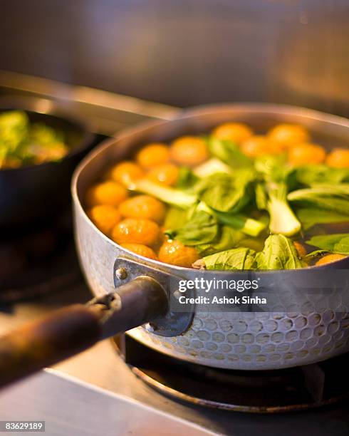 boiled fishball soup cooking on a stove - fishball stock-fotos und bilder