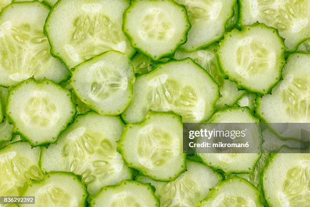 ripe, sliced, fresh fruits, organic cucumber - cucumber leaves stock-fotos und bilder