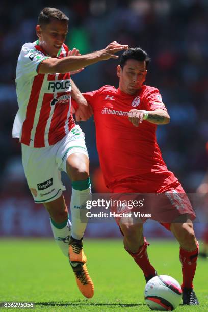 Igor Lichnovsky of Necaxa struggles for the ball with Rubens Sambueza of Toluca during the fifth round match between Toluca and Necaxa as part of the...