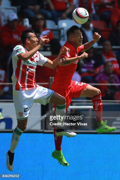 Daniel Alvarez of Necaxa struggles for the ball with Rodrigo Salinas of Toluca during the fifth round match between Toluca and Necaxa as part of the...