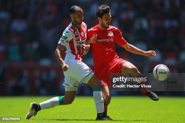 Carlos Gonzalez of Necaxa struggles for the ball with Santiago Garcia of Toluca during the fifth round match between Toluca and Necaxa as part of the...