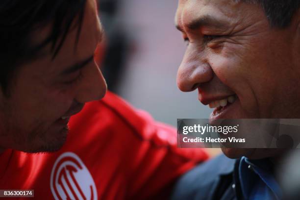 Rubens Sambueza of Toluca and Ignacio Ambriz coach of Necaxa smile prior the fifth round match between Toluca and Necaxa as part of the Torneo...