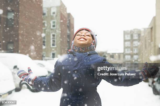 little boy enjoying snowfall - winter coat stock pictures, royalty-free photos & images