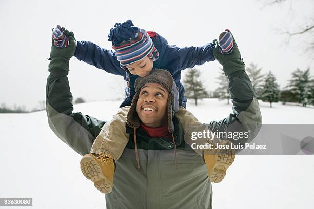 father carrying son on shoulders - west new york new jersey stock-fotos und bilder