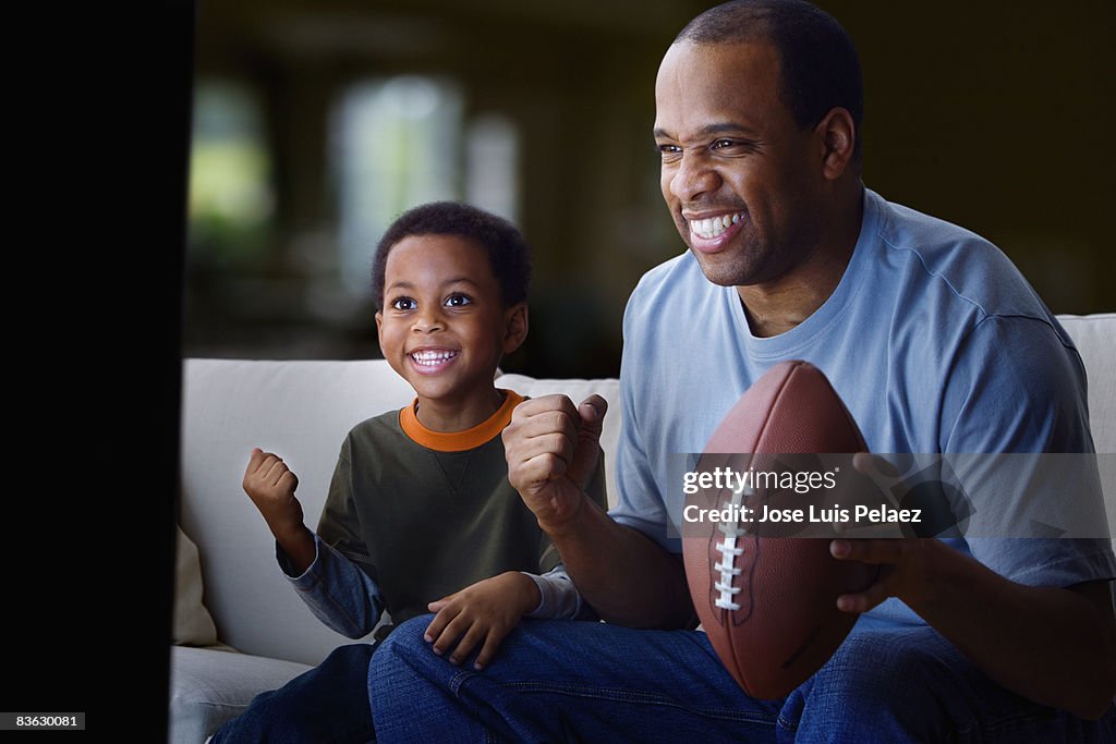 Father on son watching football game