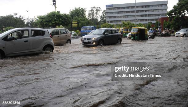 Traffic moving through waterlogged road at 32-33 light point due to rain on August 21, 2017 in Chandigarh, India. Heavy rainfall on morning brought...