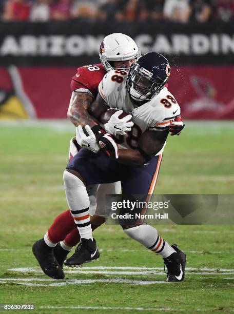 Dion Sims of the Chicago Bears catches a pass while being hit by Scooby Wright III of the Arizona Cardinals at University of Phoenix Stadium on...