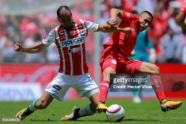 Carlos Gonzalez of Necaxa struggles for the ball with Osvaldo Gonzalez of Toluca during the fifth round match between Toluca and Necaxa as part of...