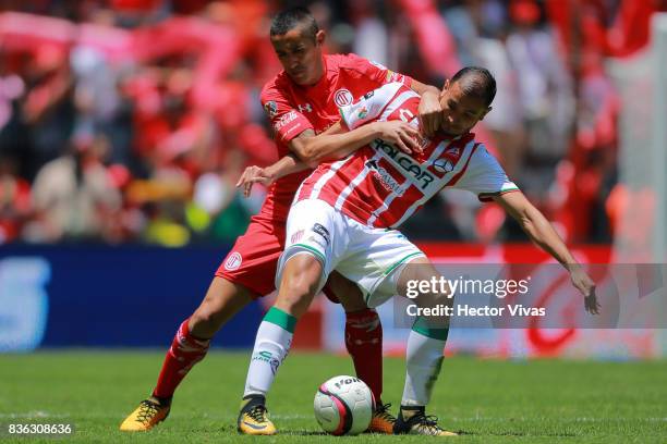 Carlos Gonzalez of Necaxa struggles for the ball with Osvaldo Gonzalez of Toluca during the fifth round match between Toluca and Necaxa as part of...