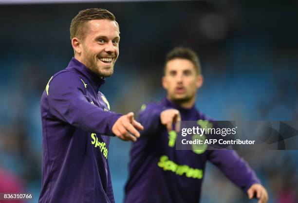 Everton's Icelandic midfielder Gylfi Sigurdsson warms up with Everton's Belgian striker Kevin Mirallas prior to the English Premier League football...