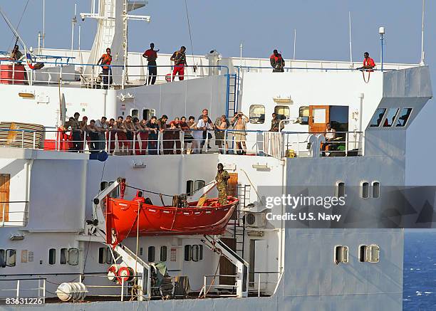 In this handout image provided by the U.S. Navy, the crew of the merchant vessel MV Faina stand on the deck after a U.S. Navy request to check on...