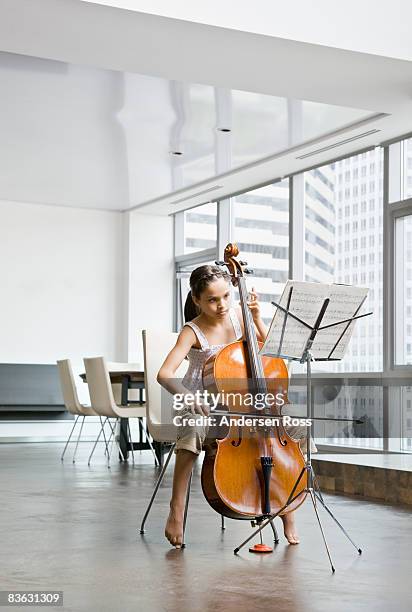 girl practicing her cello - cello stock pictures, royalty-free photos & images