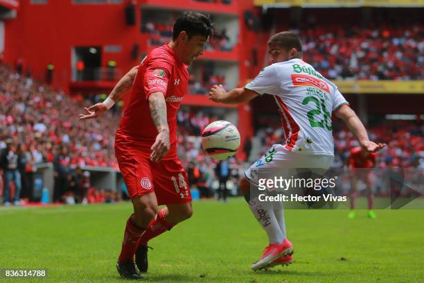 Rubens Sambueza of Toluca struggles for the ball with Jairo Gonzalez of Necaxa during the fifth round match between Toluca and Necaxa as part of the...