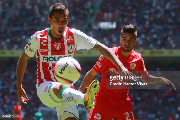 Jesus Isijara of Necaxa struggles for the ball with Rodrigo Gomez of Toluca during the fifth round match between Toluca and Necaxa as part of the...
