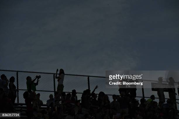 The silhouettes of viewers are seen during the solar eclipse totality on the campus of Southern Illinois University in Carbondale, Illinois, U.S., on...