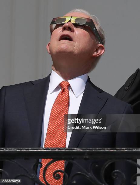Attorney General Jeff Sessions wears special glasses to view the solar eclipseat the White House on August 21, 2017 in Washington, DC. Millions of...