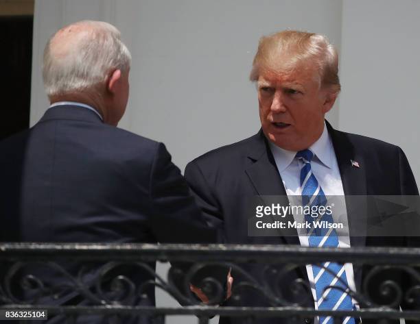 President Donald Trump shakes hands with Attorney General Jeff Sessions before viewing the solar eclipse at the White House on August 21, 2017 in...