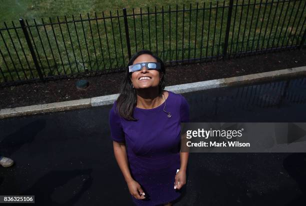 News reporter Kristen Welker wears special glasses to view the solar eclipse, at the White House on August 21, 2017 in Washington, DC. Millions of...