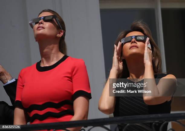 First lady Melania Trump and Ivanka Trump wear special glasses to view the solar eclipse at the White House on August 21, 2017 in Washington, DC....
