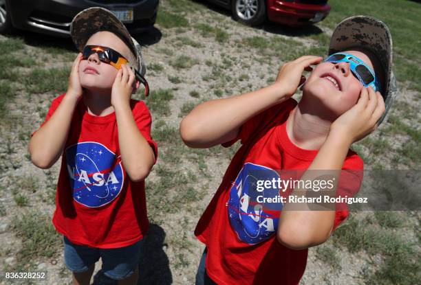 Two boys watch the solar eclipse at Texas Motor Speedway on August 21, 2017 in Fort Worth, Texas. Millions of people have flocked to areas of the...