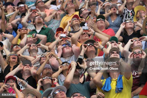 People watch the solar eclipse at Saluki Stadium on the campus of Southern Illinois University on August 21, 2017 in Carbondale, Illinois. Although...