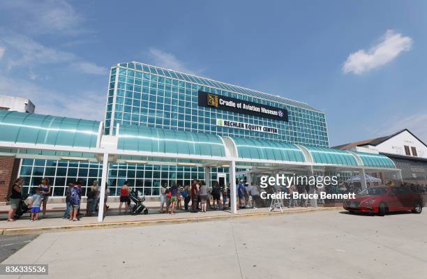 Spectators stand on line for the Cradle of Aviation Museum partial eclipse of the sun viewing party on August 21, 2017 at the Cradle of Aviation...