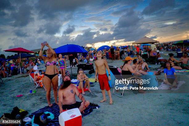 Solar eclips fans look on as totality ends over one of last vantage points where totality was visible on August 21, 2017 in Isle of Palms, S.C. It's...