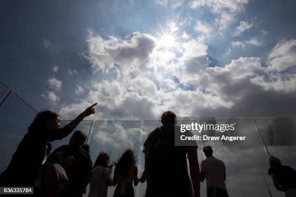 People view the solar eclipse at 'Top of the Rock' observatory at Rockefeller Center, August 21, 2017 in New York City. While New York City is not in...