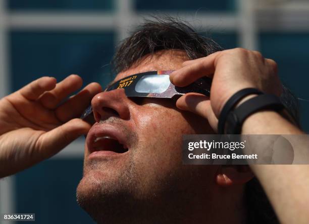 Spectator looks skyward during a partial eclipse of the sun on August 21, 2017 at the Cradle of Aviation Museum in Garden City, New York. Millions of...