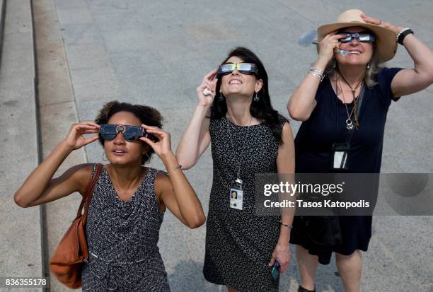 People gather at the Lincoln Memorial to watch the solar eclipse on August 21, 2017 in Washington, DC. Millions of people have flocked to areas of...