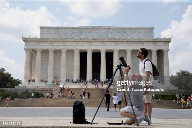 Photographers set up near the Lincoln Memorial to the get a view of the solar eclipse on August 21, 2017 in Washington, DC. Millions of people have...