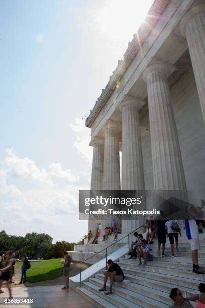 People gather at the Lincoln Memorial to watch the solar eclipse on August 21, 2017 in Washington, DC. Millions of people have flocked to areas of...