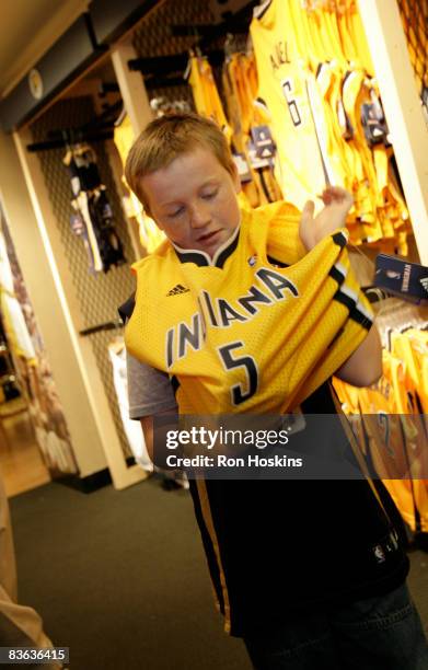 Justin Williams of Indianapolis tries on a T.J. Ford jersey prior to the Pacers taking on the Oklahoma City Thunder at Conseco Fieldhouse on November...