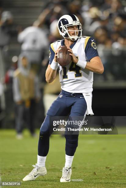 Sean Mannion of the Los Angeles Rams drops back to pass against the Oakland Raiders during the fourth quarter of their preseason NFL football game at...