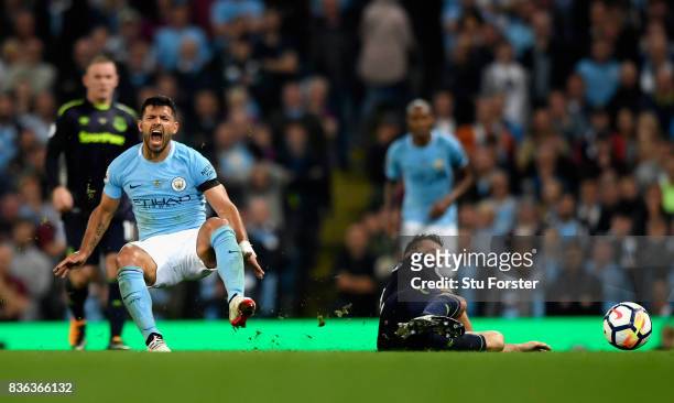 Morgan Schneiderlin of Everton fouls Sergio Aguero of Manchester City prior to being shown a second yellow card during the Premier League match...