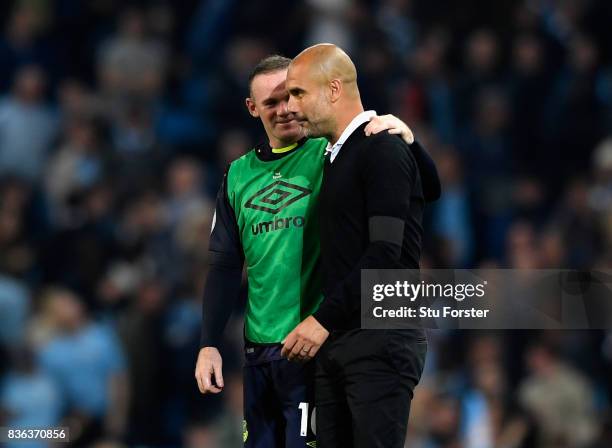 Josep Guardiola, Manager of Manchester City speaks with Wayne Rooney of Everton following the Premier League match between Manchester City and...