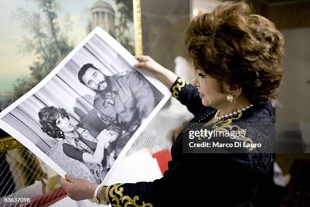 Italian actress Gina Lollobrigida is seen in her house as she show a photograph of her with Fidel Castro taken by Henry Kissinger on October 14, 2008...