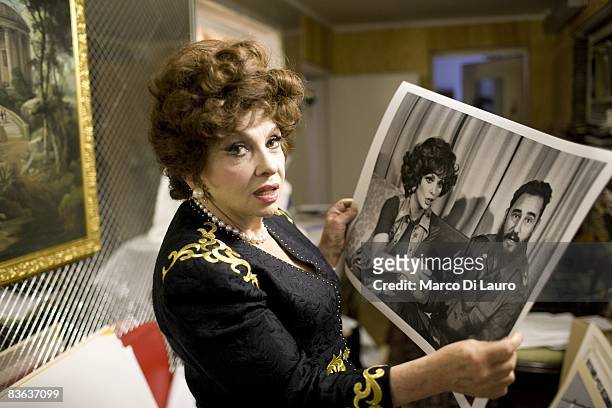 Italian actress Gina Lollobrigida is seen in her house as she show a photograph of her with Fidel Castro taken by Henry Kissinger on October 14, 2008...