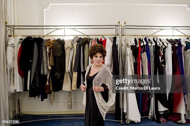 Italian actress Gina Lollobrigida is seen in the atelier of the Italian couturier Fausto Sarli as she tries on same dresses on October 14, 2008 in...