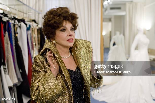 Italian actress Gina Lollobrigida is seen in the atelier of the Italian couturier Fausto Sarli as she tries on same dresses on October 14, 2008 in...