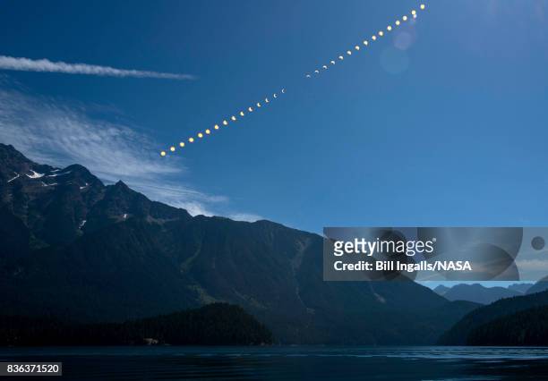 In this NASA handout composite image, the progression of a partial solar eclipse August 21, 2017 over Ross Lake, in Northern Cascades National Park,...