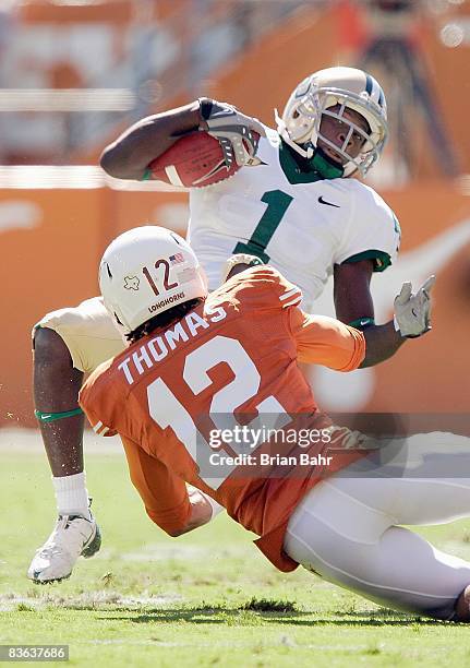 Dwain Crawford of the Baylor Bears carries the ball as he is tackled by Earl Thomas of the Texas Longhorns on November 8, 2008 at Darrell K...