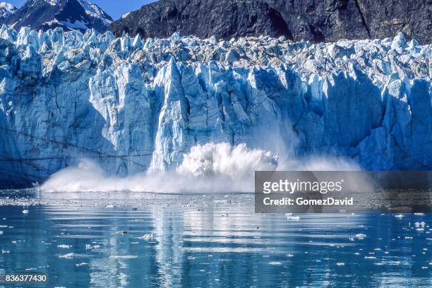 glacier calving into glacier bay national park - alaska stock pictures, royalty-free photos & images