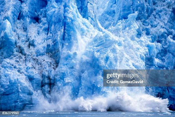 glacier calving into alaskan bay - glacier calving stock pictures, royalty-free photos & images