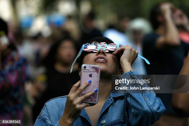 People view the solar eclipse at Battery Park on August 21, 2017 in New York City.